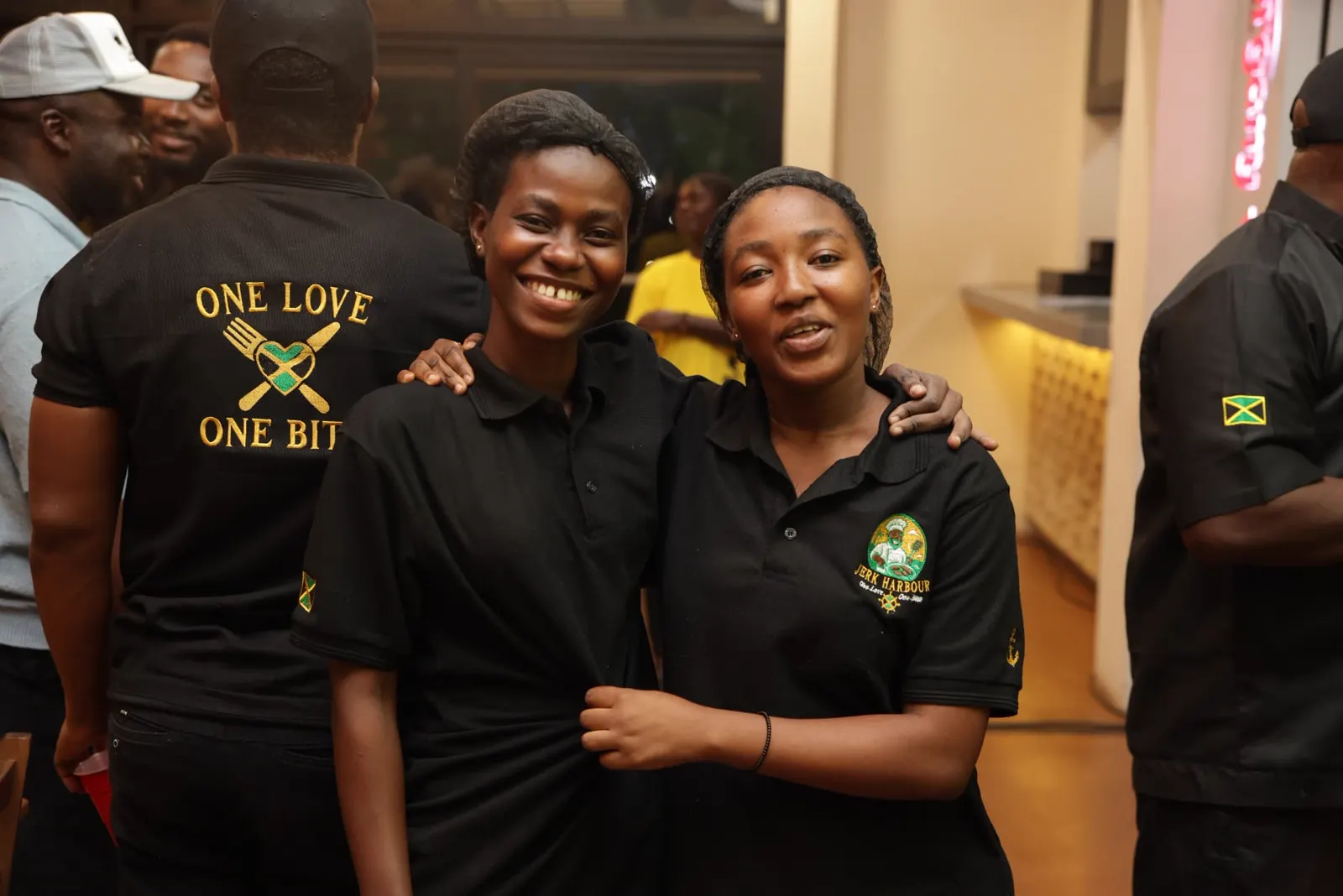 Jerk Harbour team members in One Love One Bite uniforms